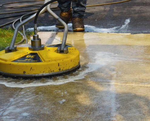 Professional using power washing surface cleaner